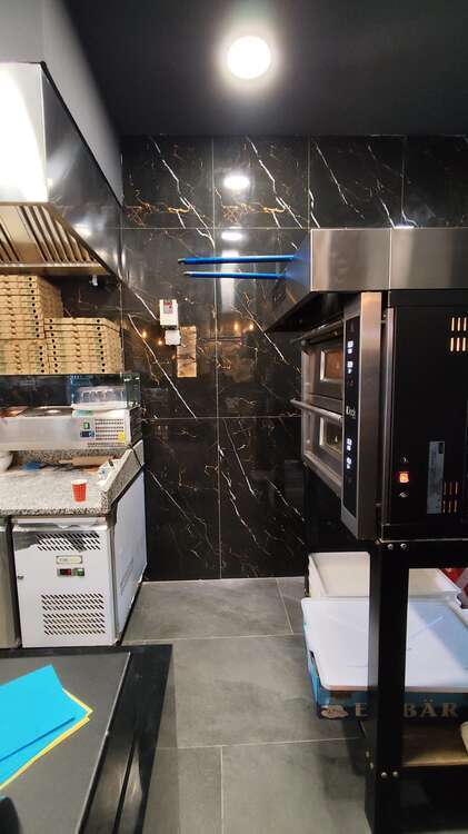 Rivestimento effetto marmo nero in una cucina professionale