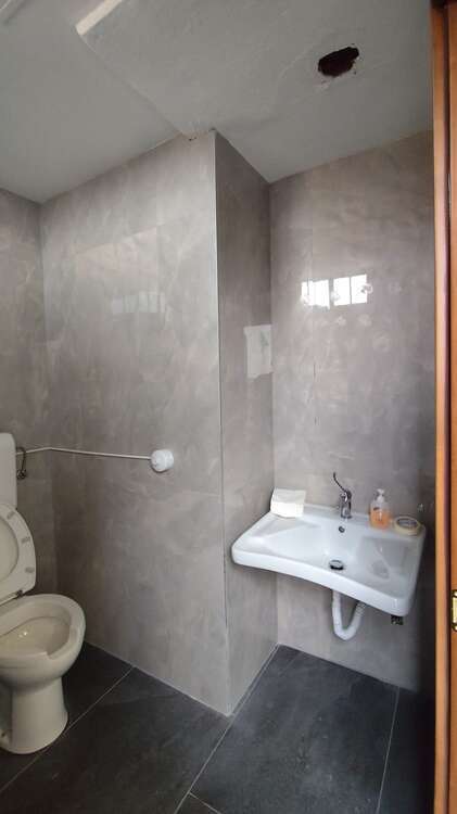 Bagno con rivestimento grigio in grande formato